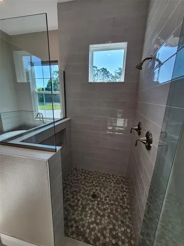 a bathroom with a shower and a sink