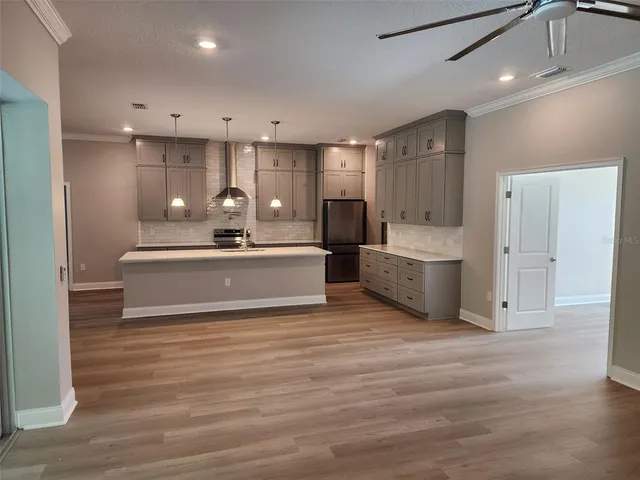 a view of a kitchen with sink stainless steel appliances and cabinets