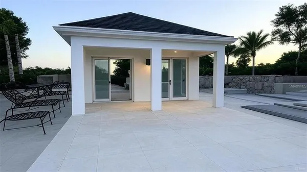 a view of a house with porch and furniture