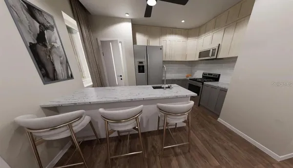 a kitchen with stainless steel appliances granite countertop a sink and a refrigerator