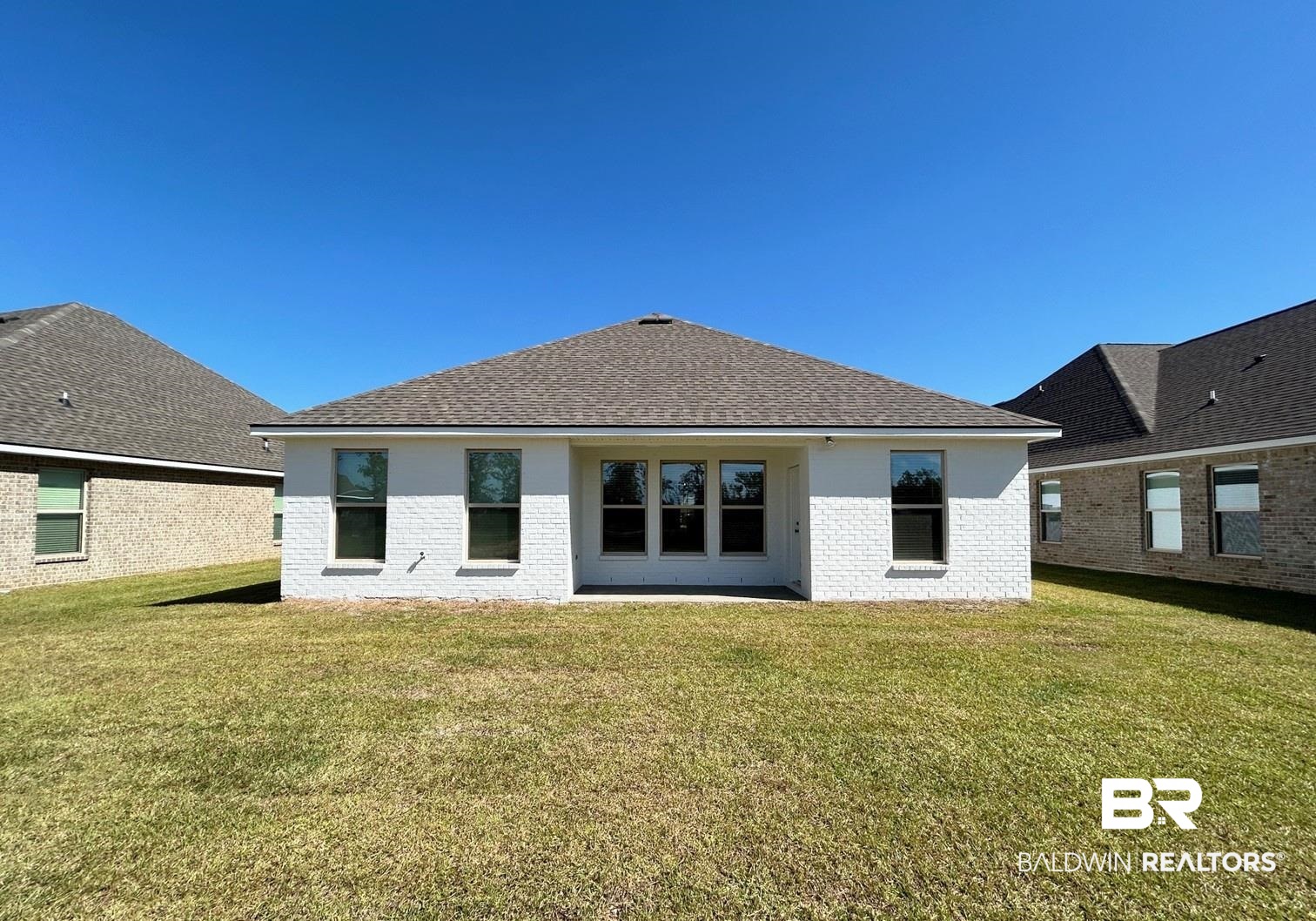 880 Sumter Loop Foley, AL 36535 - Photo 12 of 14 Rear view of house featuring a lawn