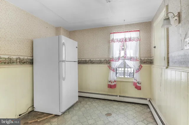 a white refrigerator freezer sitting in a kitchen