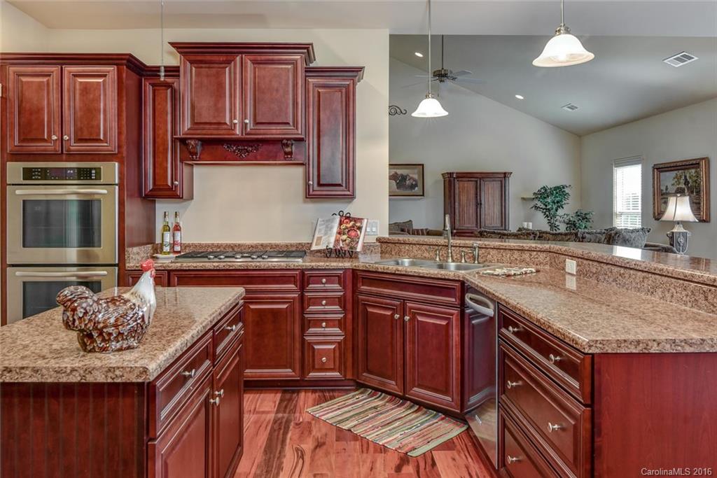 944-a R A R Thompson Road, Unit 25 Mill Spring, NC 28756 - Photo 14 of 24 a kitchen with stainless steel appliances granite countertop a sink stove and refrigerator