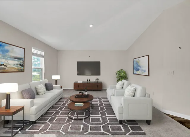 a living room with furniture a rug and a window