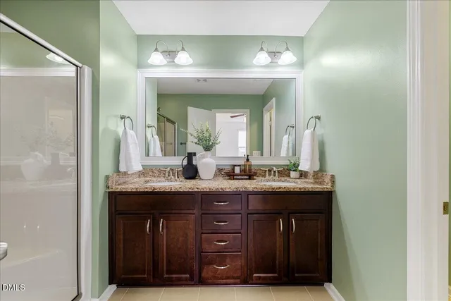 a bathroom with a granite countertop sink a mirror and a vanity