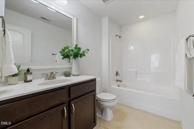 an empty room with ceiling fan and window