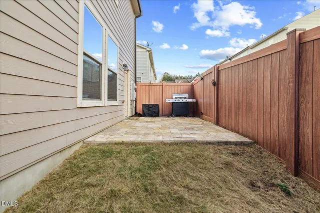 an aerial view of a house with a swimming pool and outdoor space