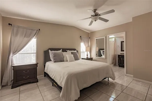 a bedroom with a bed and a ceiling fan