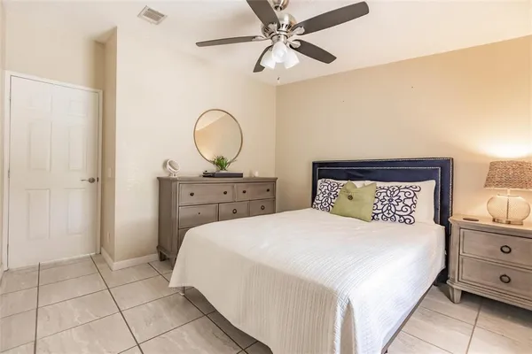 a bedroom with a bed a closet and cabinets