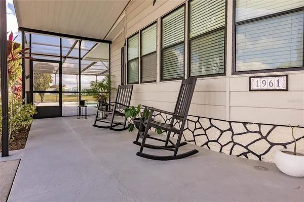 a view of a livingroom with furniture and a large window