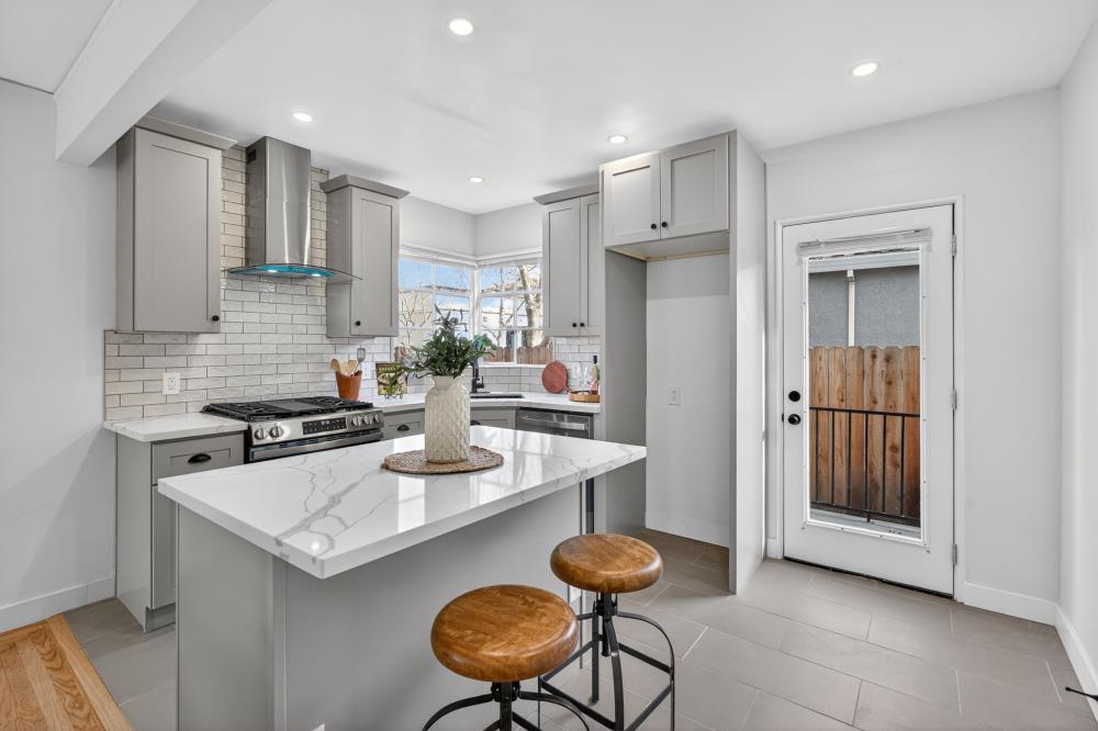 2008 Argail Way Sacramento, CA 95822 - Photo 17 of 53 a kitchen with a sink a refrigerator and chairs