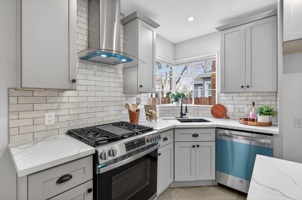 2008 Argail Way Sacramento, CA 95822 - Photo 21 of 53 a kitchen with a stove and white cabinets