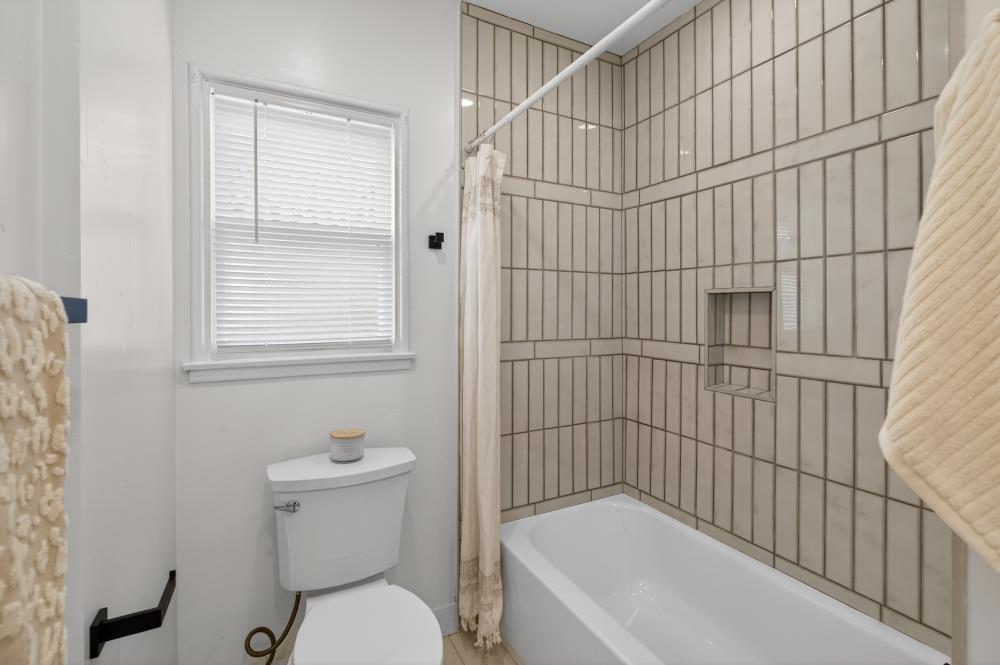 2008 Argail Way Sacramento, CA 95822 - Photo 25 of 53 a bathroom with a toilet and a bathtub