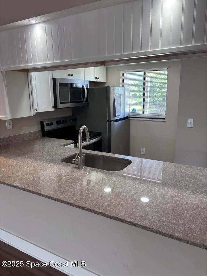 1720 Murrell Road, Unit 214 Rockledge, FL 32955 - Photo 2 of 8 a kitchen with a sink and a window