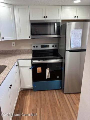 a kitchen with granite countertop a stove and a microwave