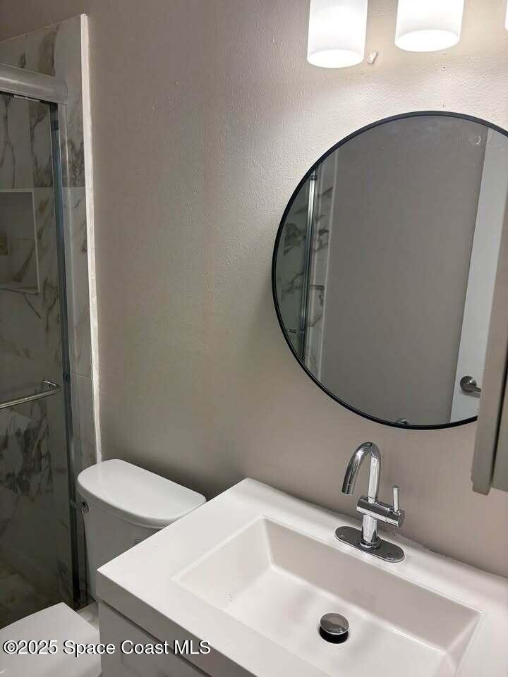 1720 Murrell Road, Unit 214 Rockledge, FL 32955 - Photo 6 of 8 a bathroom with a sink and a mirror