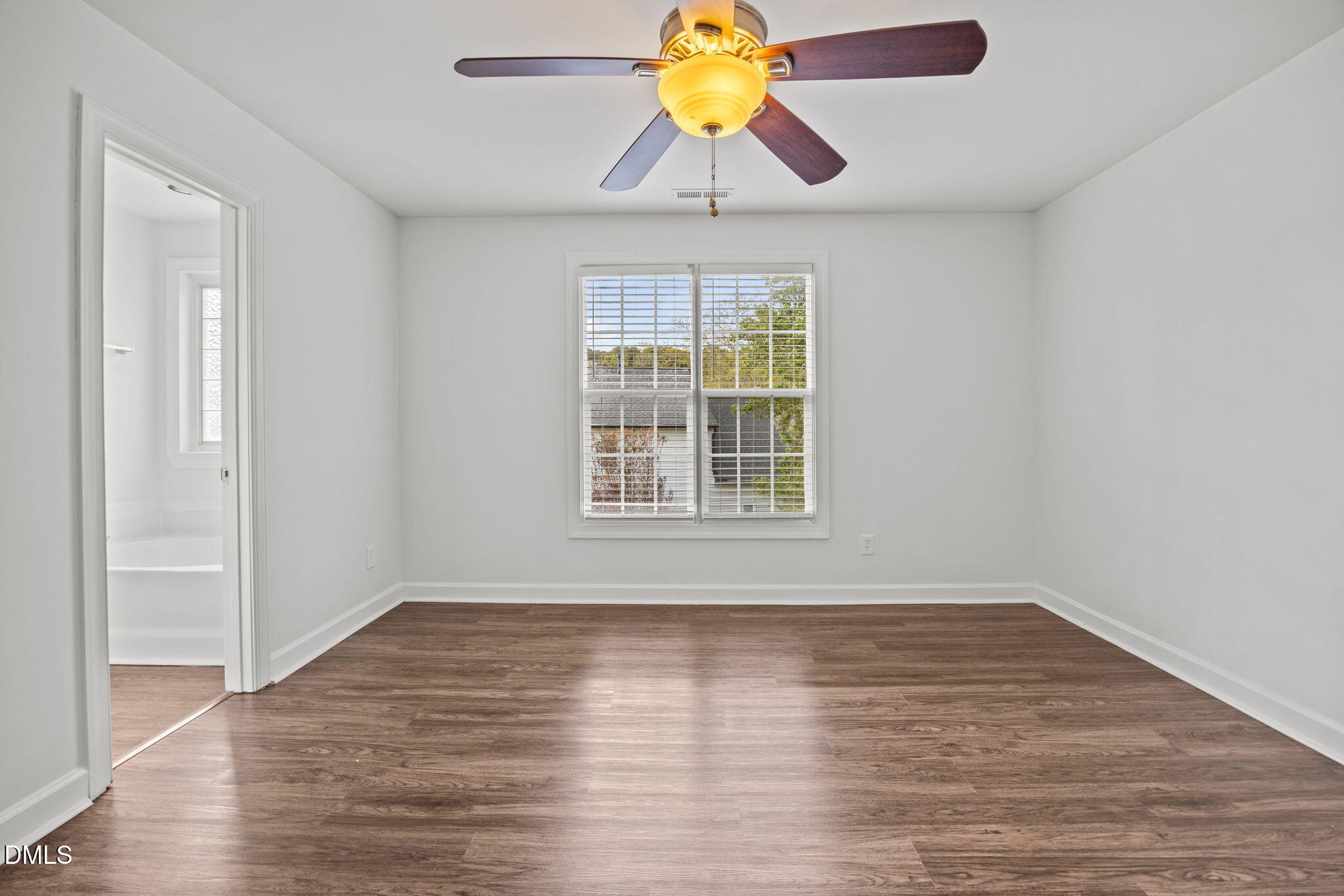 9220 Pennythorne Court Raleigh, NC 27615 - Photo 4 of 49 wooden floor in an empty room with a window