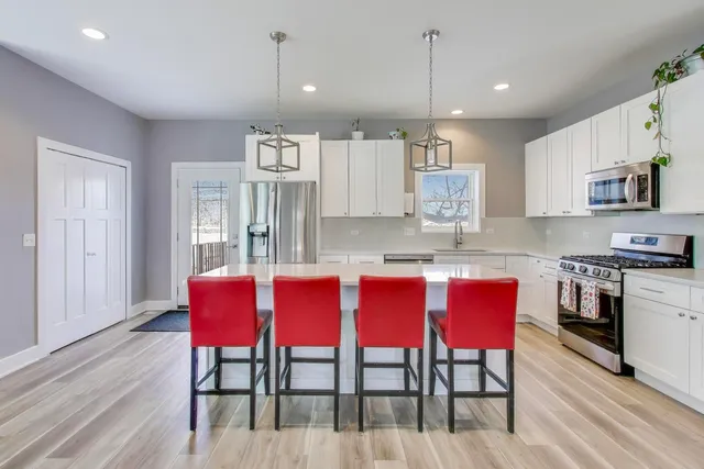 a bedroom with a bed chair and a window