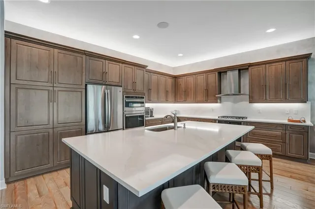 a kitchen with refrigerator cabinets dining table and chairs
