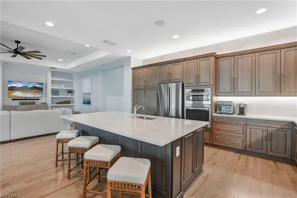 a large kitchen with kitchen island a table and chairs