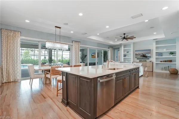 a kitchen with stainless steel appliances granite countertop counter space and wooden floors