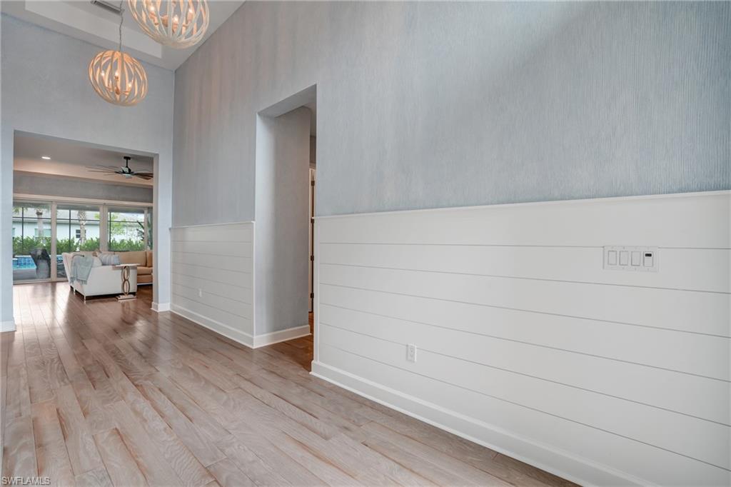 12068 Azalea Way Naples, FL 34120 - Photo 21 of 50 a view of livingroom with hardwood floor and a large window