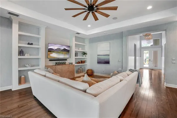a living room with furniture and a wooden floor