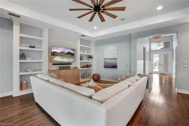 a living room with furniture and a wooden floor
