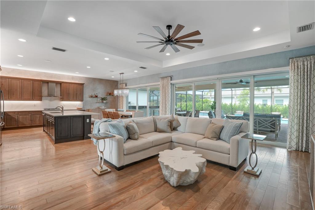12068 Azalea Way Naples, FL 34120 - Photo 24 of 50 a living room with furniture and a large window