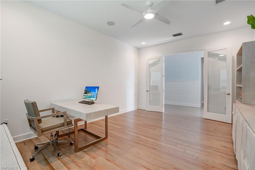 12068 Azalea Way Naples, FL 34120 - Photo 26 of 50 a workspace with furniture and wooden floor