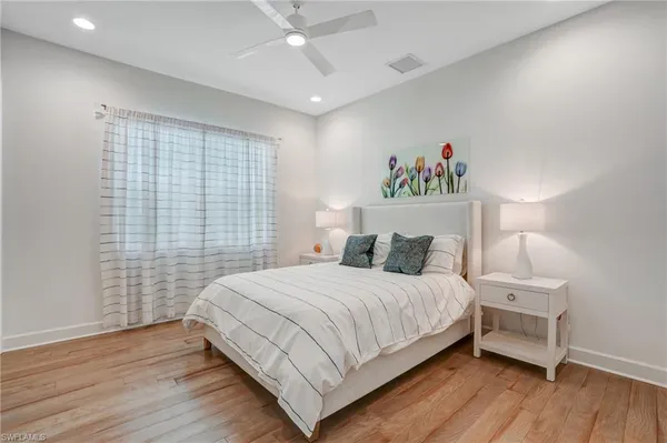 a bedroom with a bed and a night stand