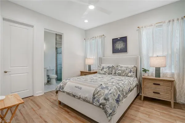 a bedroom with a bed and a night stand