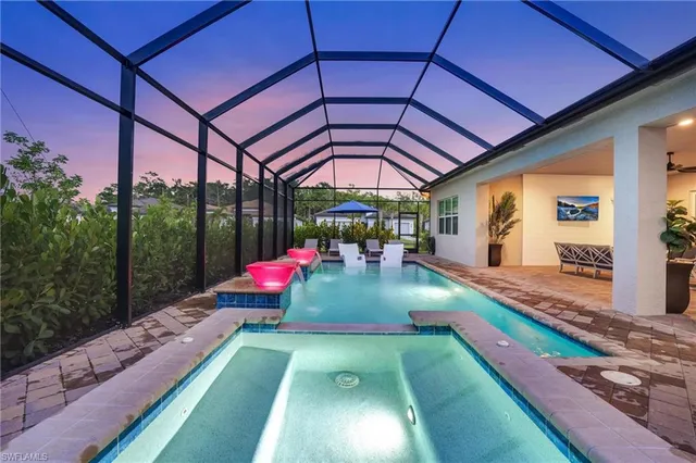 a view of a backyard with table and chairs under an umbrella