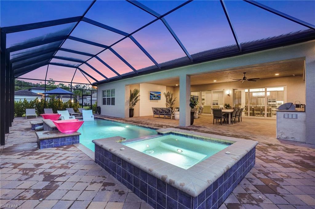 12068 Azalea Way Naples, FL 34120 - Photo 10 of 50 a view of a backyard with a patio and swimming pool