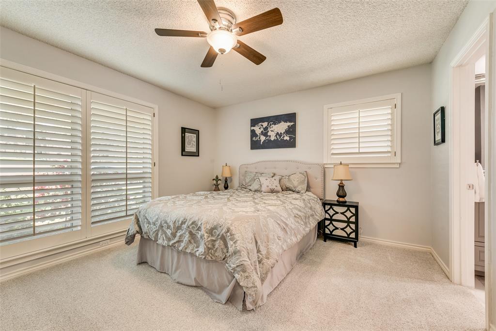 805 Crowley Road Arlington, TX 76012 - Photo 21 of 26 a spacious bedroom with a bed and a window