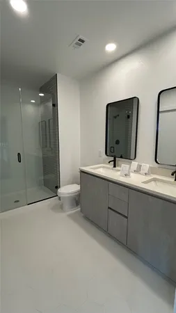 a bathroom with double vanity sink and a mirror