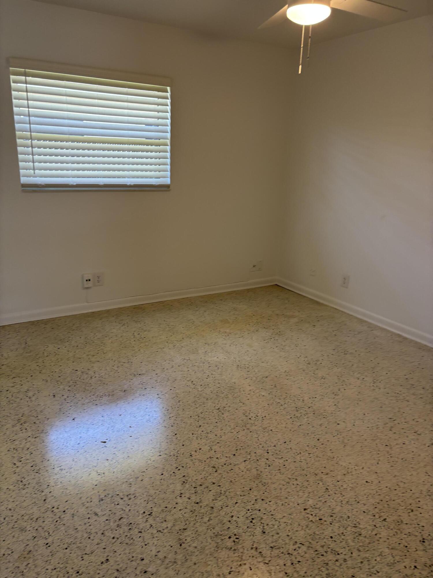 751 Hummingbird Way, Unit 5 North Palm Beach, FL 33408 - Photo 12 of 18 an empty room with a window