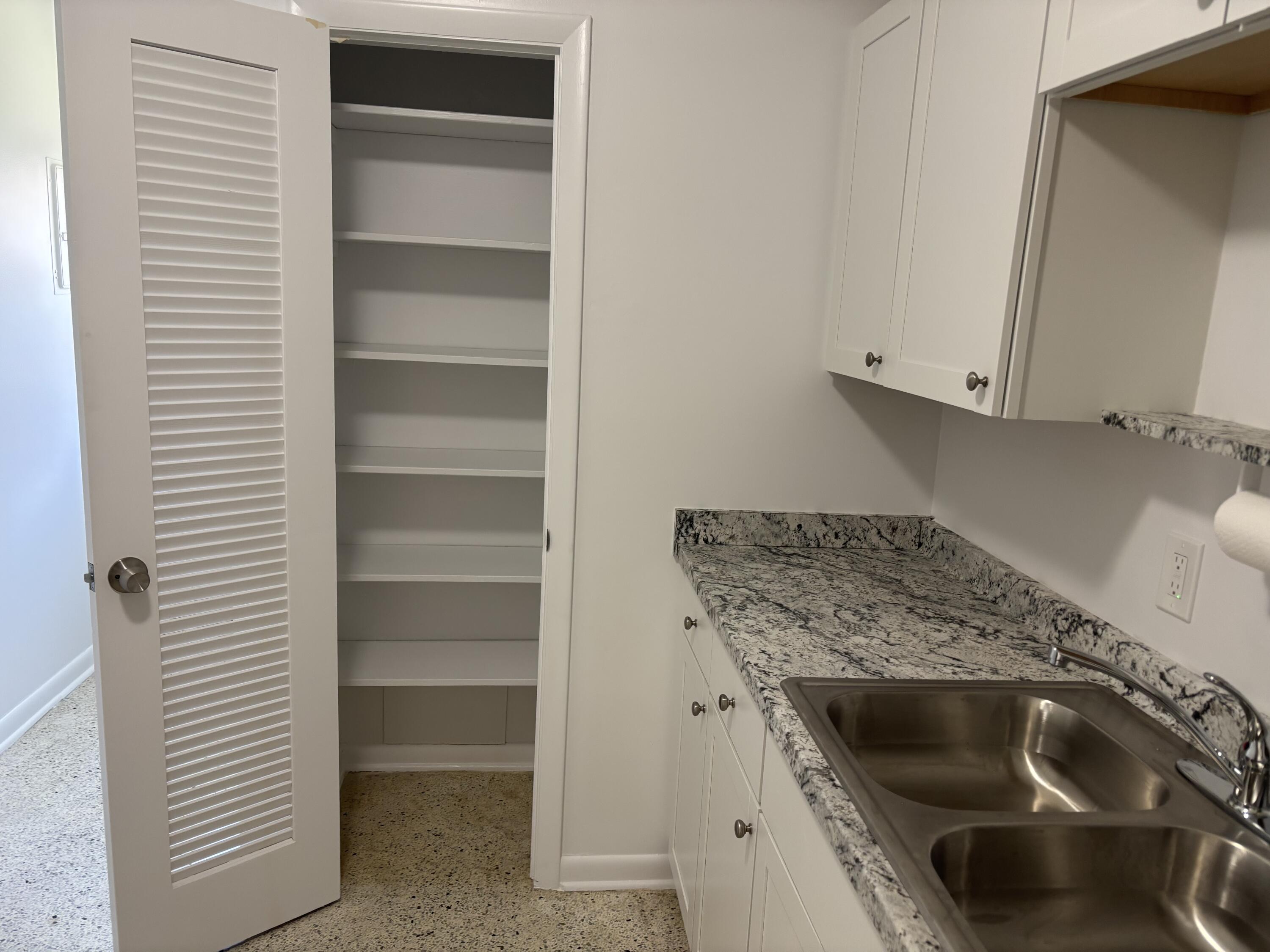 751 Hummingbird Way, Unit 5 North Palm Beach, FL 33408 - Photo 5 of 18 a kitchen with sink and cabinets