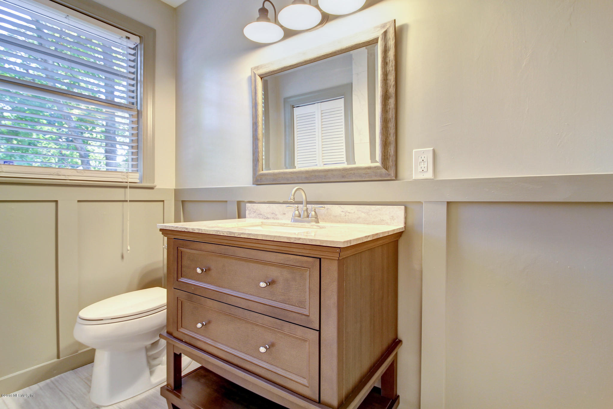 1273 Lechlade Circle Jacksonville, FL 32205 - Photo 16 of 23 a bathroom with a toilet sink and mirror