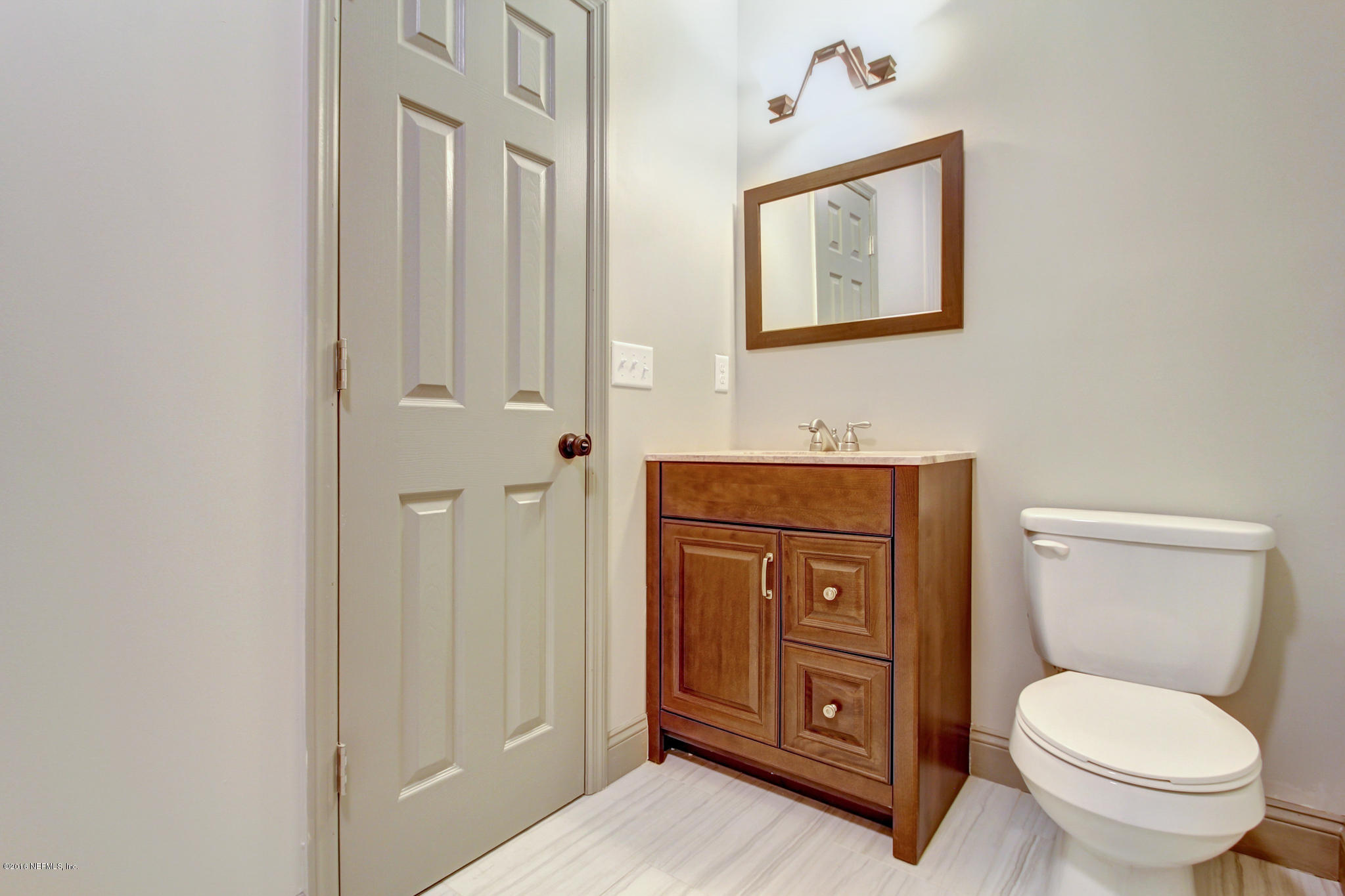1273 Lechlade Circle Jacksonville, FL 32205 - Photo 18 of 23 a bathroom with a toilet a sink and mirror