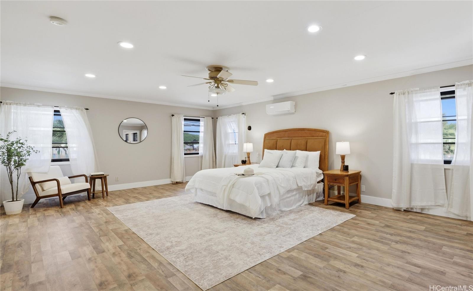 91-779 Fort Weaver Road Ewa Beach, HI 96706 - Photo 2 of 25 Spacious upstairs primary suite featuring split AC, a ceiling fan, and durable, modern flooring.