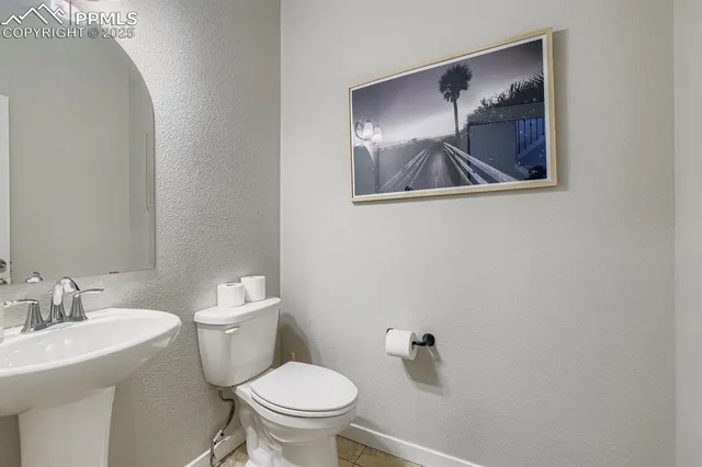 a white toilet sitting next to a bathroom sink