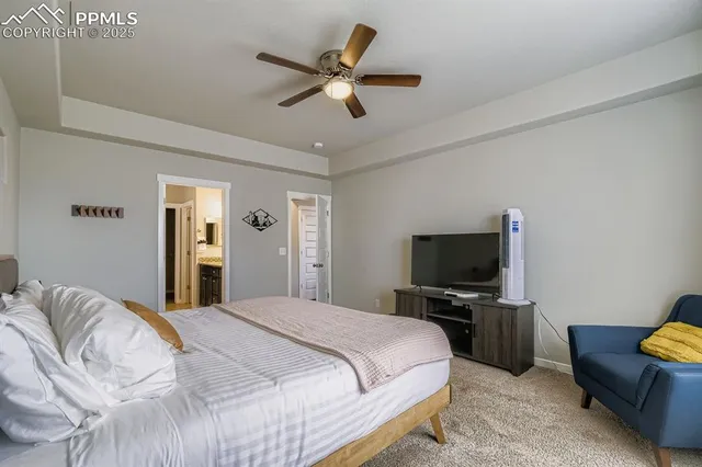 a bedroom with a large bed and a flat tv screen on a dresser
