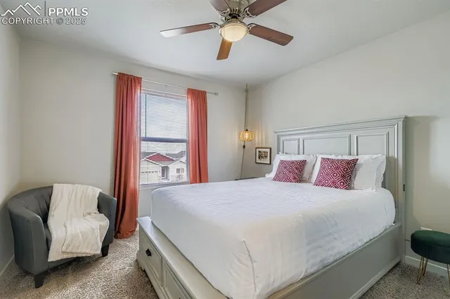 a bedroom with a large bed and a chandelier