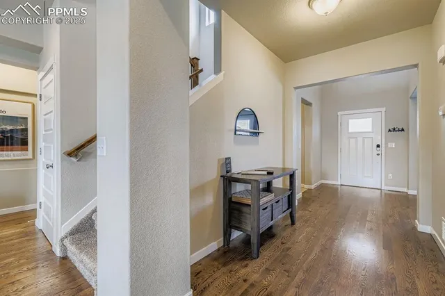 a view of a workspace with wooden floor