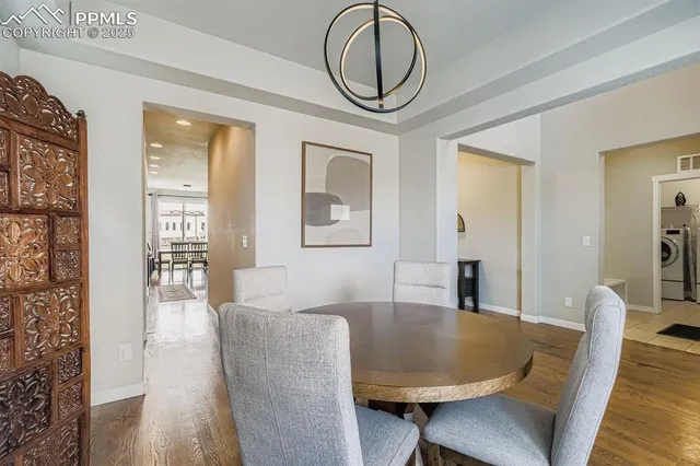 a dining room with furniture and wooden floor