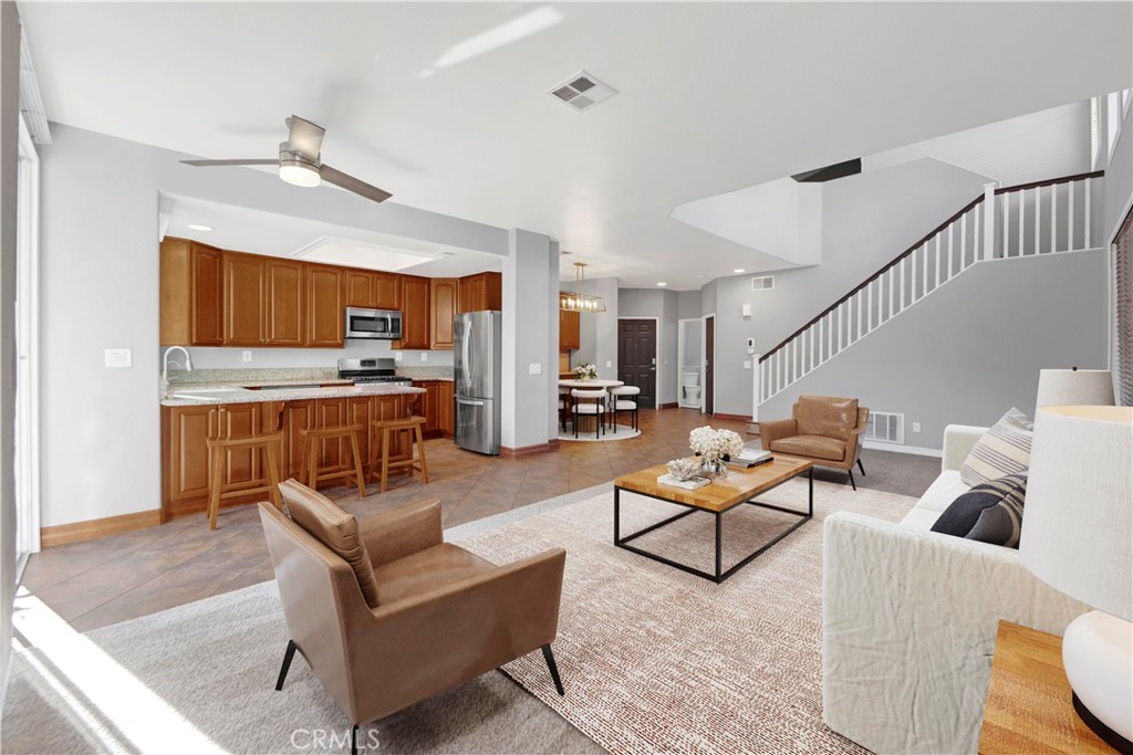 27626 Iris Place Castaic, CA 91384 - Photo 8 of 28 The downstairs virtually staged living room with the entry way in the background.