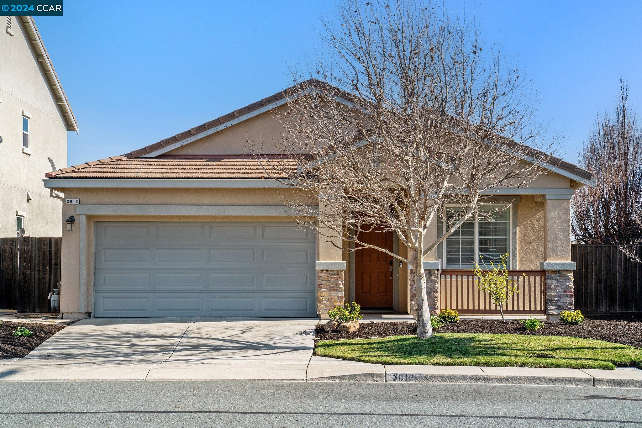 a front view of a house with garage and window