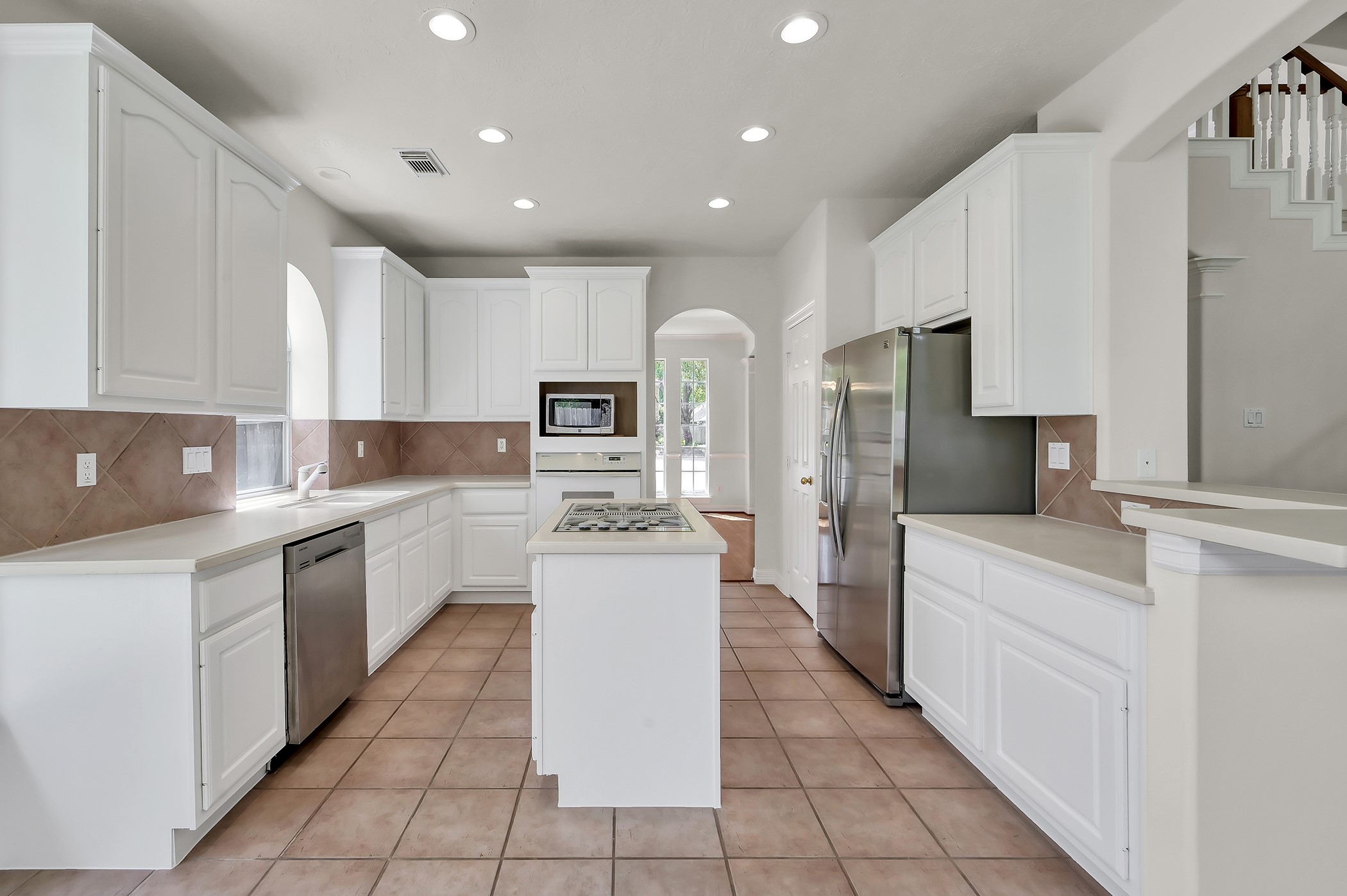 18310 Rittenhouse Park Court Spring, TX 77379 - Photo 11 of 35 Island kitchen with gas cooktop, stainless dishwasher and stainless refrigerator, which stays with the house!