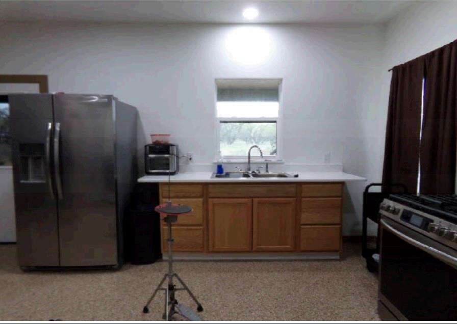 3349 Fm 2652 Graham, TX 76450 - Photo 10 of 12 a kitchen with stainless steel appliances a refrigerator and a stove